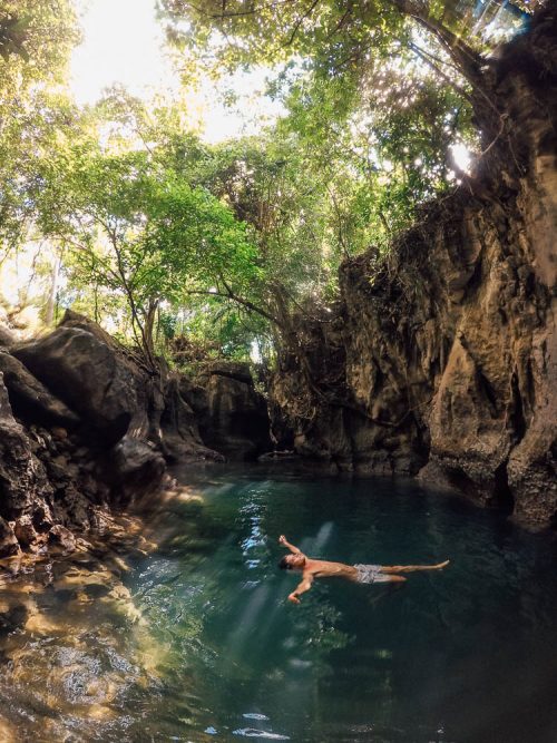 "Travelers enjoy floating in Tayangban Cave Pool"